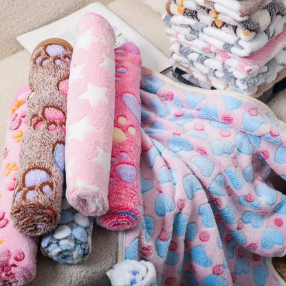 Rolled Blankora Snuggle Square fleece pet mats in pink, brown and blue patterns